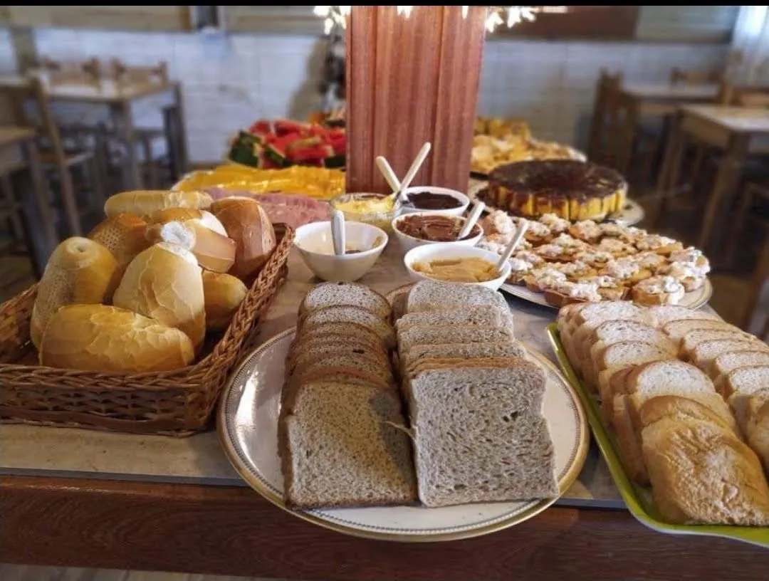 Café da manhã da Pousada Marluah com pães, frios e doces